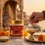 Hand placing camphor in diya beside Labh Ganga Bhimseni camphor jar in a pooja setup.